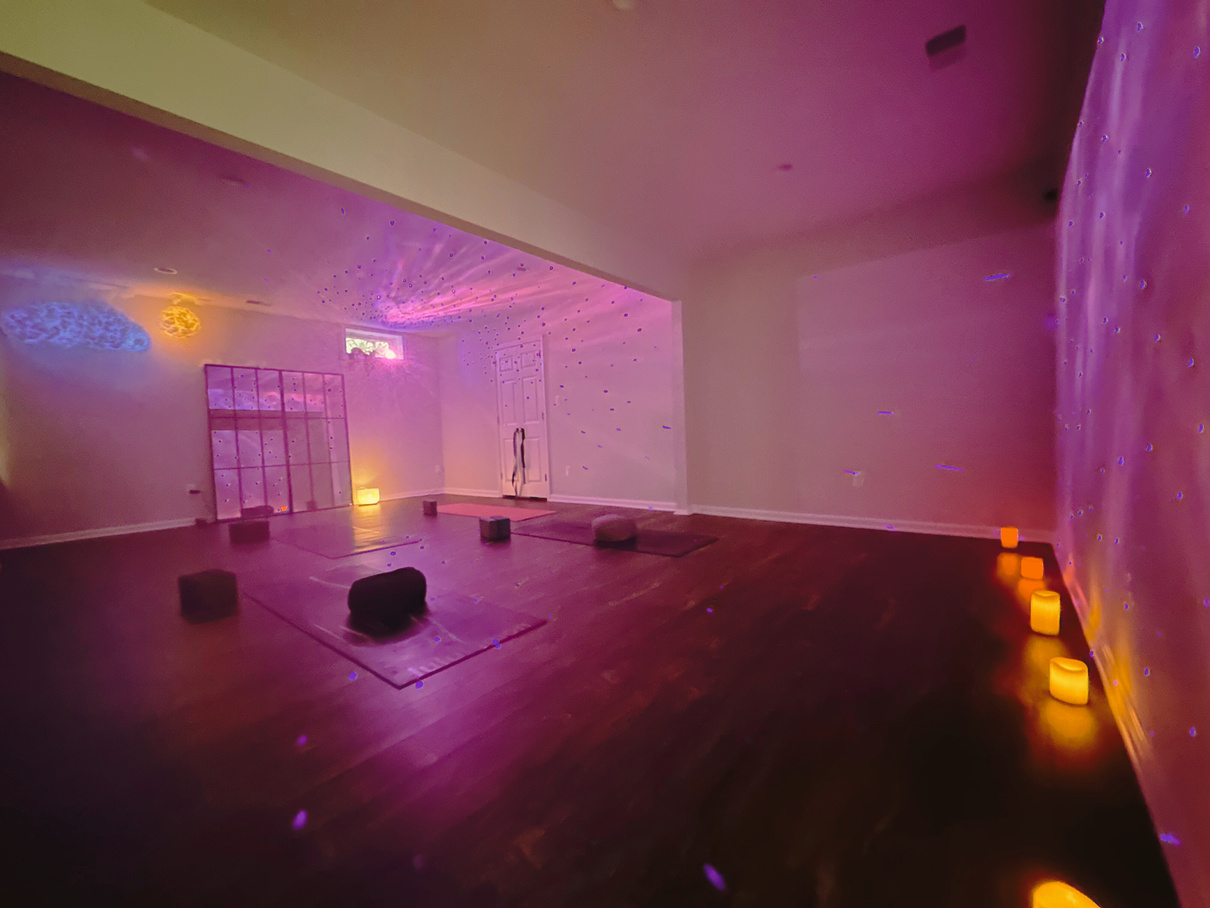 a healing yoga and breathing room with purple lights on the walls